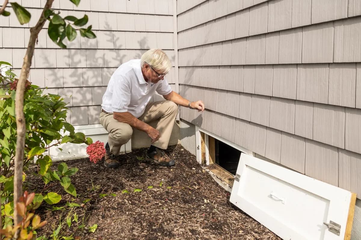 Contractor checking the exterior of a house during a home inspection